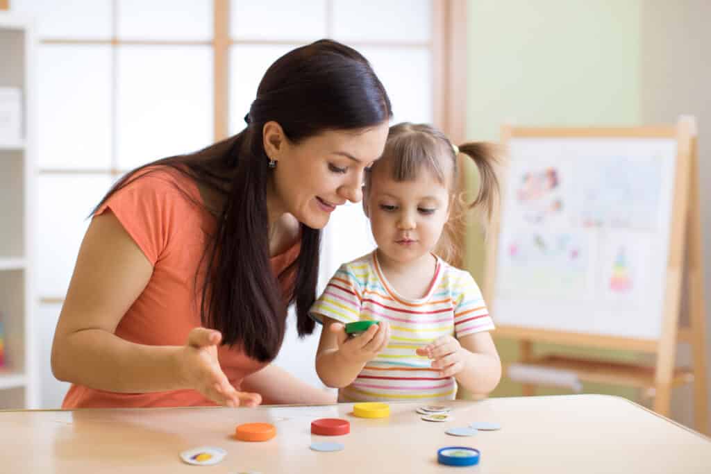 therapist and child looking at toys doing a task
