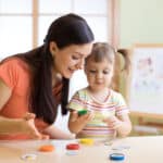therapist and child looking at toys doing a task