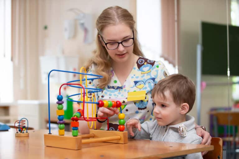 child therapist and toddler working on a puzzle together