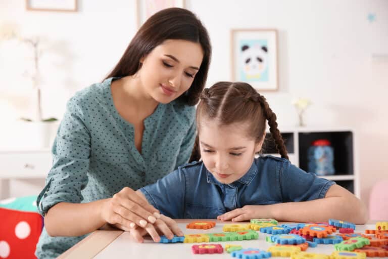 child therapist and child working on a puzzle together