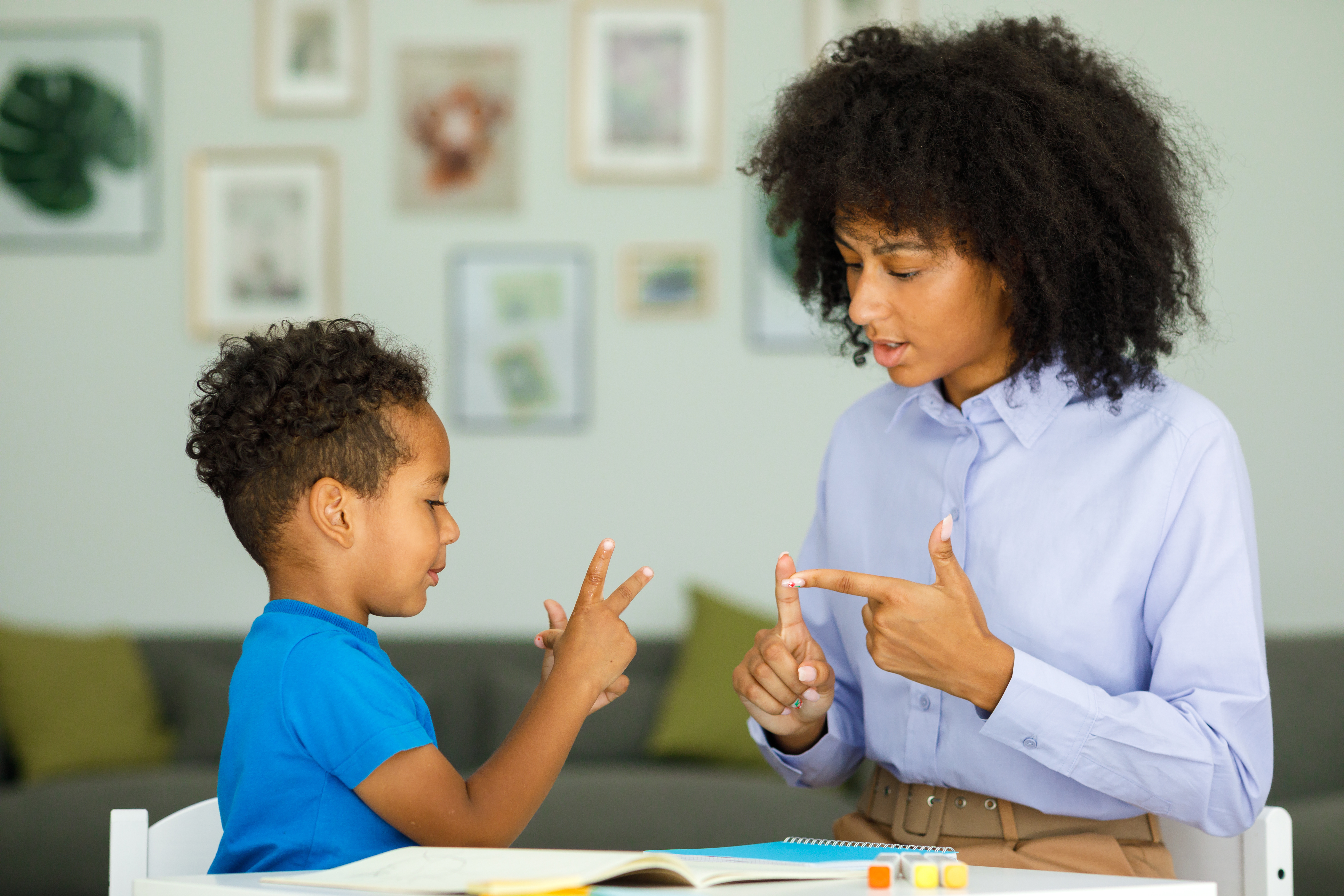 child and therapist signing to eachother